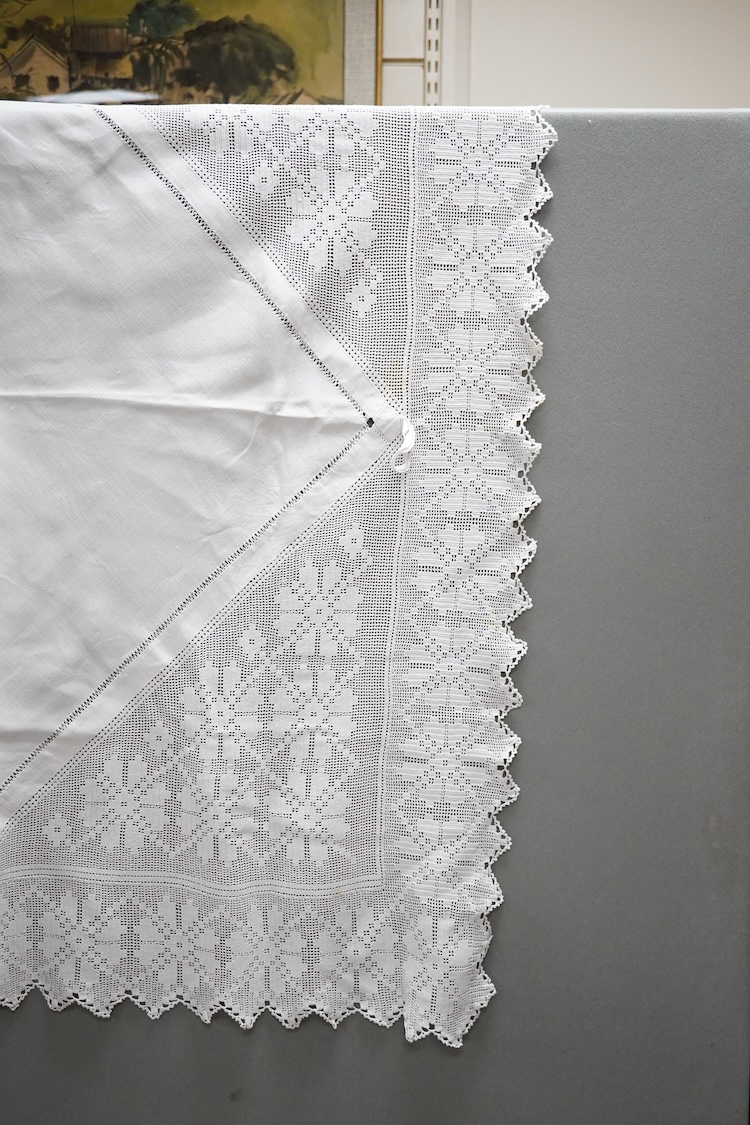 Two boxes of mixed white on white embroidered linen and cotton table cloths etc, some with crochet edging and cut work.